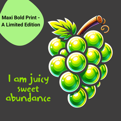 A vibrant T-shirt design featuring a bold, colorful cartoon of a bunch of green grapes against a natural background. The T-shirt includes a powerful mantra in green text: ' "I am juicy sweet abundance" The design is labeled as a "Maxi Bold Print - A limited edition" displayed on a bright green tag in the top left corner 